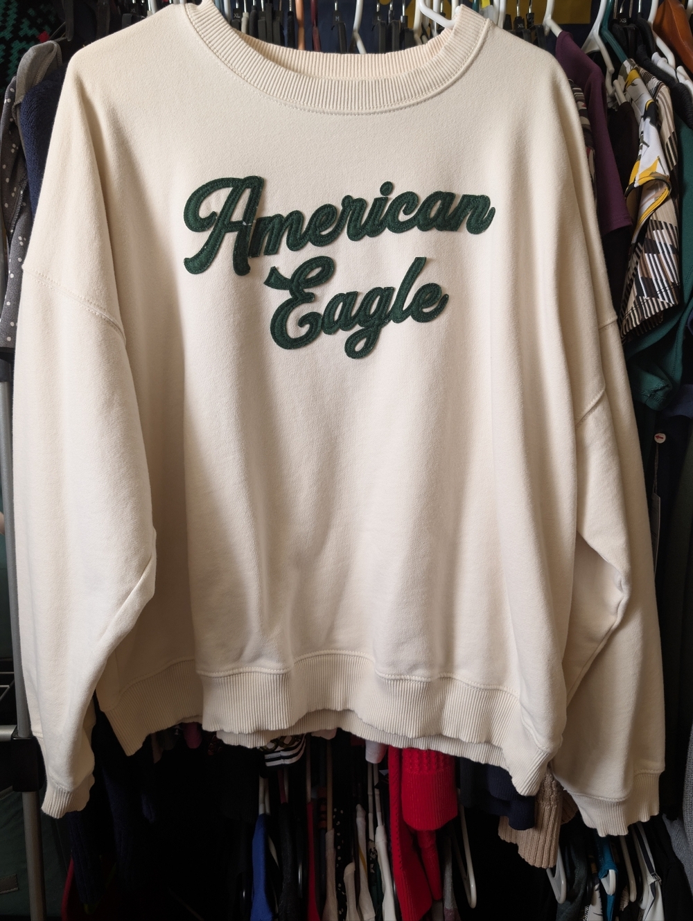American Eagle Cream Sweatshirt with Green Logo.
